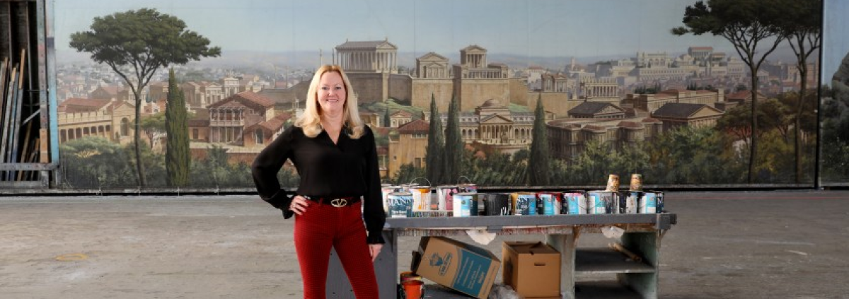 Lynne Coakley, president of JC Backings, with the “Ben-Hur” (1959) movie backdrop in the Scenic Art building at Sony Pictures Studios in Culver City. (Gary Coronado / Los Angeles Times)